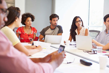 Hands pressing cookie cutters into dough