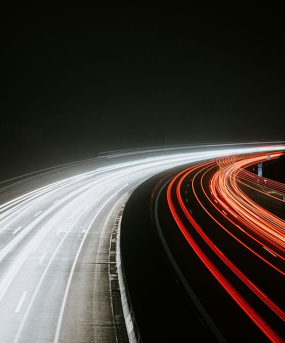 Light trails on highway representing speed and momentum