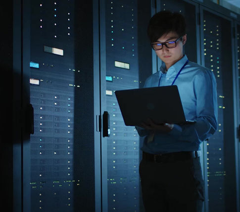 Technologist reviewing data in a server room