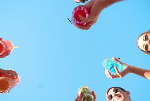 People celebrating with colorful drinks