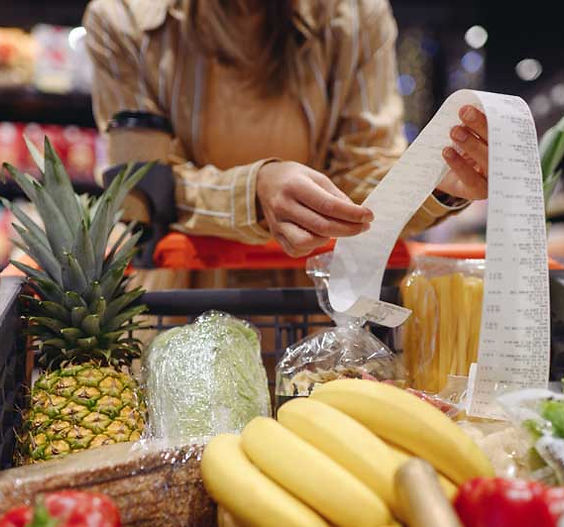 Person examining receipt in supermarket
