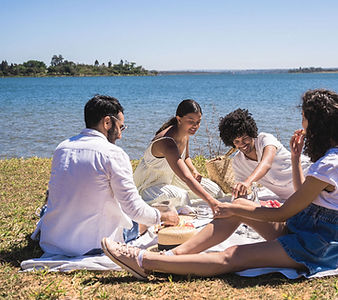 People having a picnic by a lake