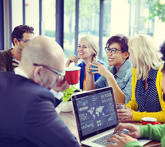 Group of people around table with charts
